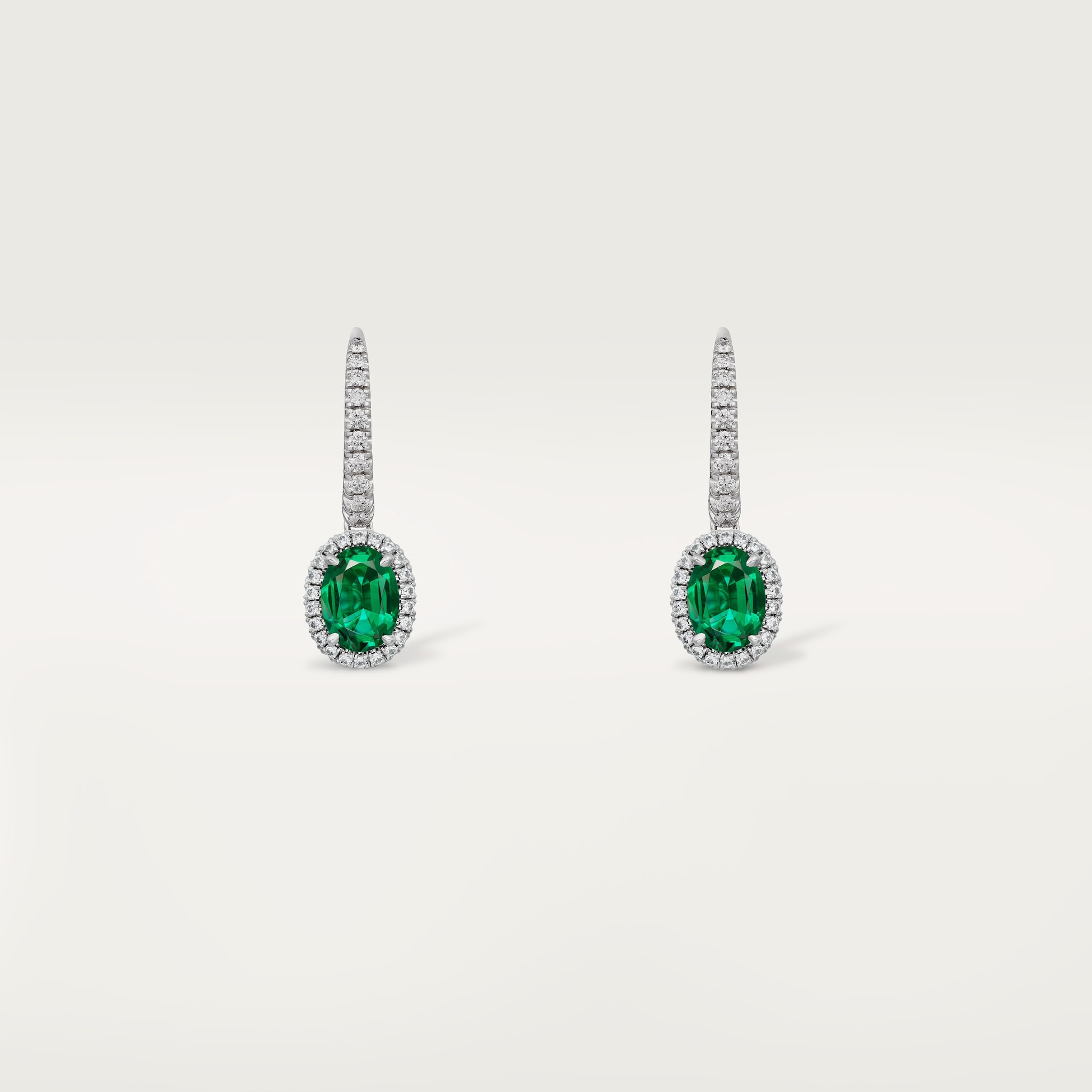 Cartier Destin&eacute;e sleeper earrings, 2 oval-cut emeralds, paved